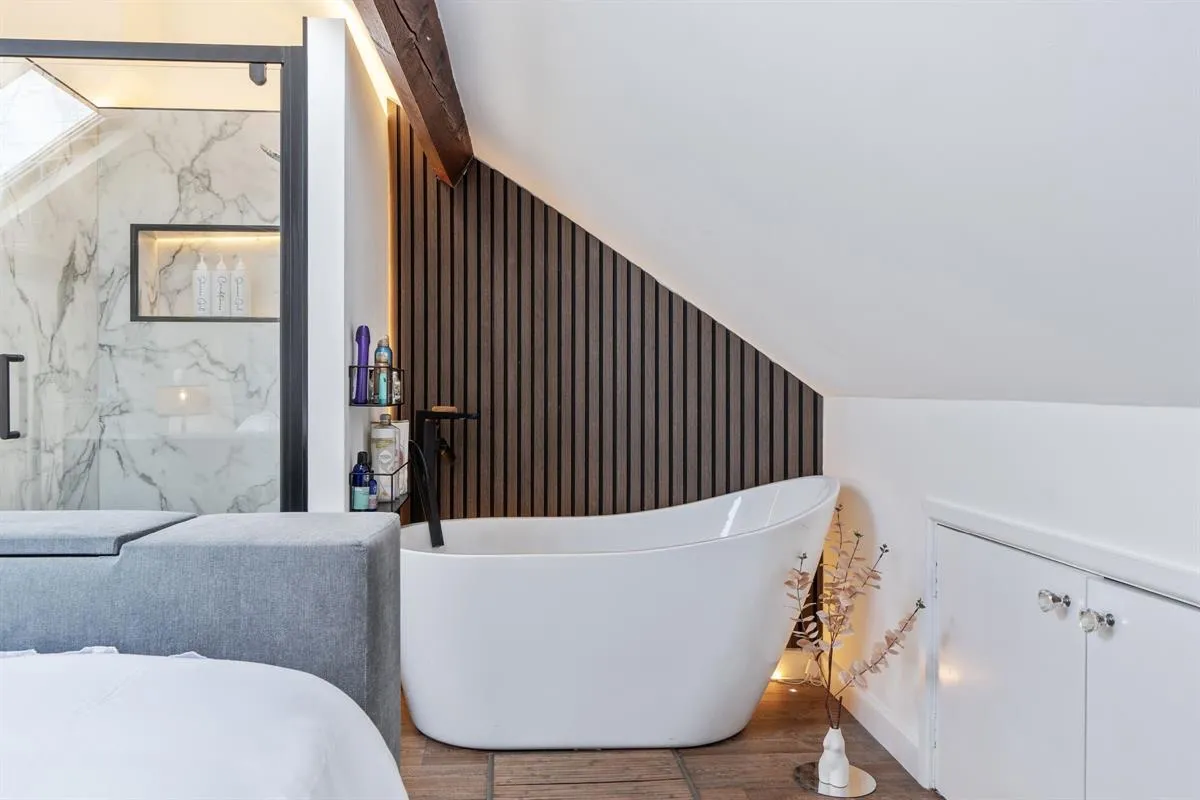 Loft bathroom with a freestanding bath, from a Dennett listing on Edgcumbe Park Road, Peverell